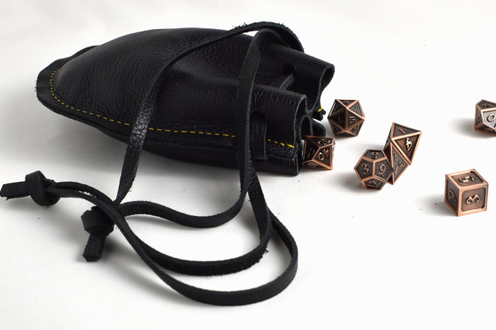 Open handcrafted black leather drawstring pouch showing spacious interior for coins, dice, jewelry, cash, keys, and everyday carry items.