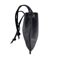 Handcrafted black leather drawstring pouch displayed showing the side view.  Great for travel gear, notebooks, electronics, and everyday carry accessories.
